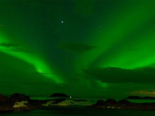 Trekking under an aurora borealis