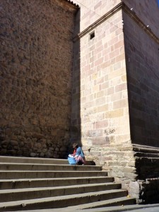 Colonial Towns Extension – A "cholita" on a church steps in Potosi