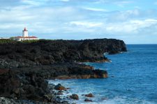 Ponta da Ilha lighthouse on black lava cliffs at the eastern tip of Pico