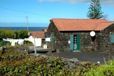 Black volcanic stone house, unpainted, on the north coast